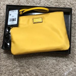 Brand new yellow DKNY wristlet with tags